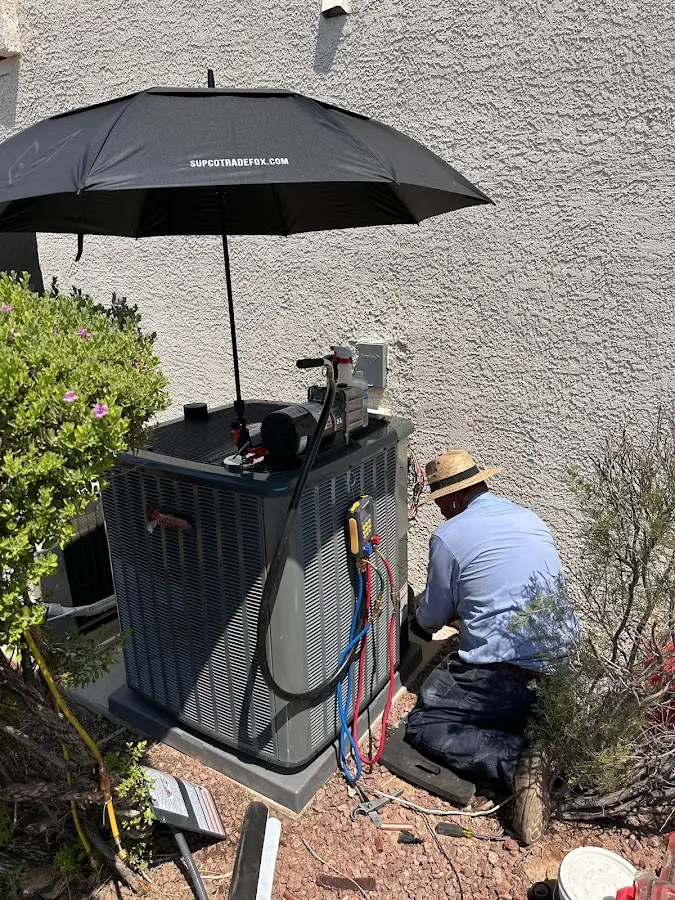 HVAC technician performing outdoor AC maintenance in Good Hope