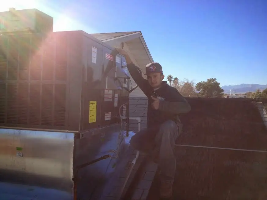 HVAC technician performing AC Tune-Up on a rooftop unit in Good Hope